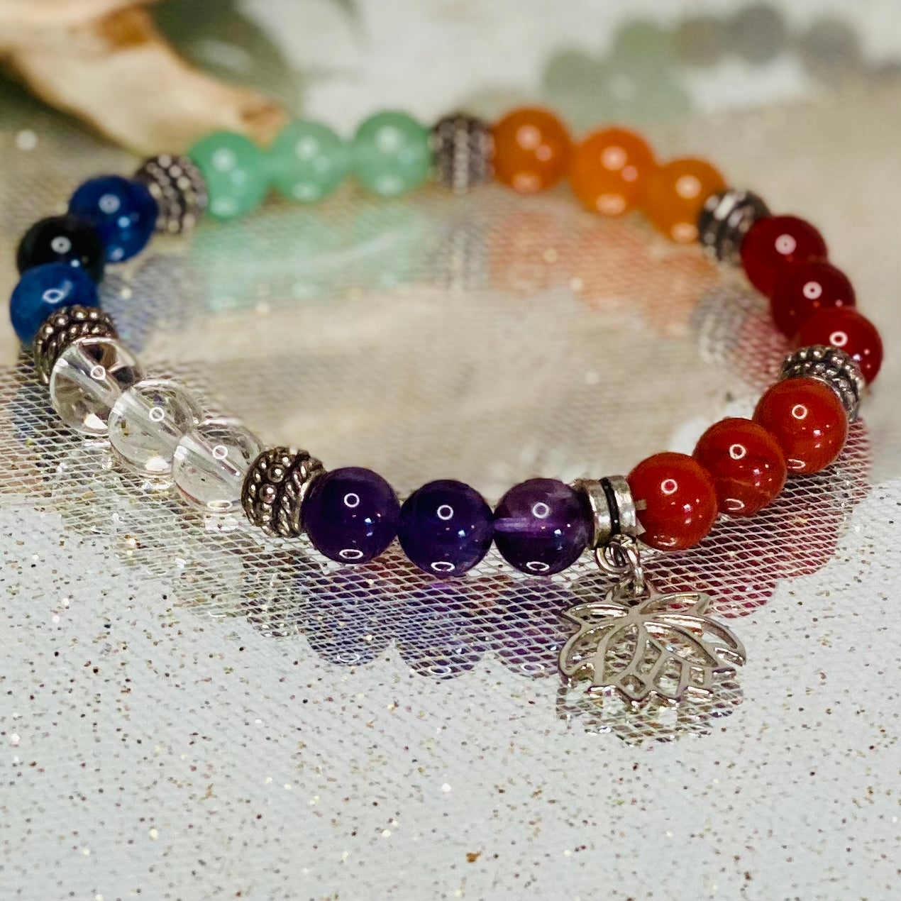 Chakra Balancing Bracelet with Red Jasper, Carnelian, Calcite, Green Aventurine, Blue Howlite, Sodalite, Amethyst, and Lotus Flower Charm