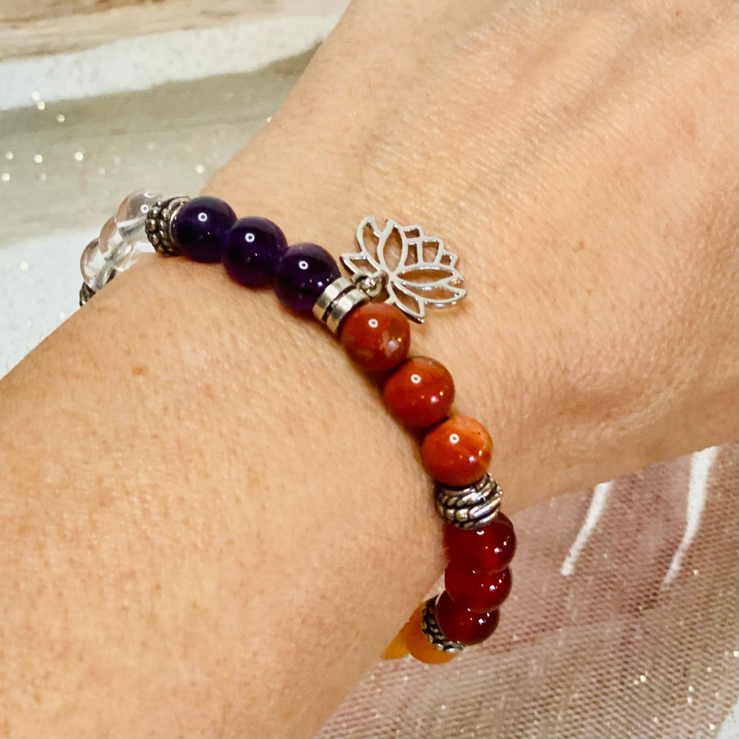Chakra Balancing Bracelet with Red Jasper, Carnelian, Calcite, Green Aventurine, Blue Howlite, Sodalite, Amethyst, and Lotus Flower Charm