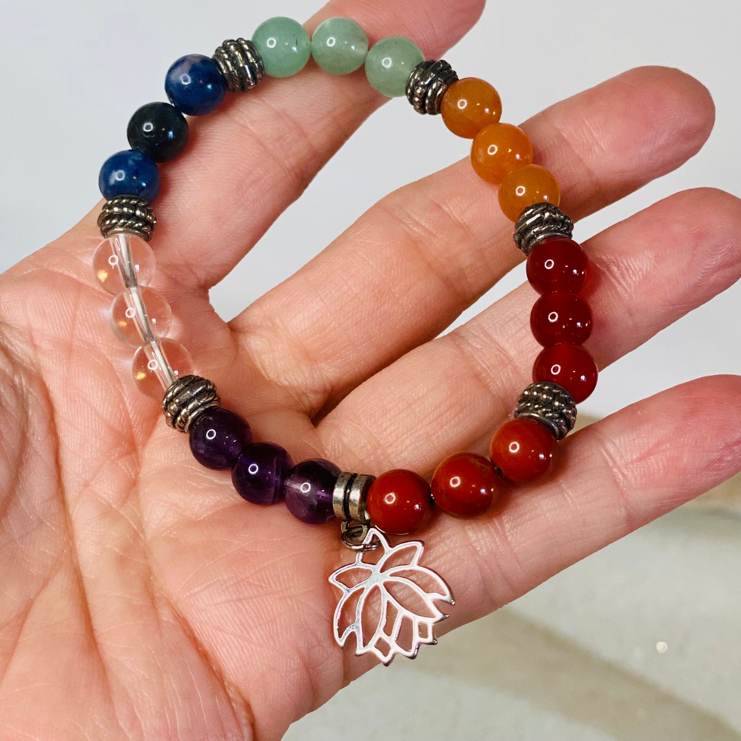 Chakra Balancing Bracelet with Red Jasper, Carnelian, Calcite, Green Aventurine, Blue Howlite, Sodalite, Amethyst, and Lotus Flower Charm
