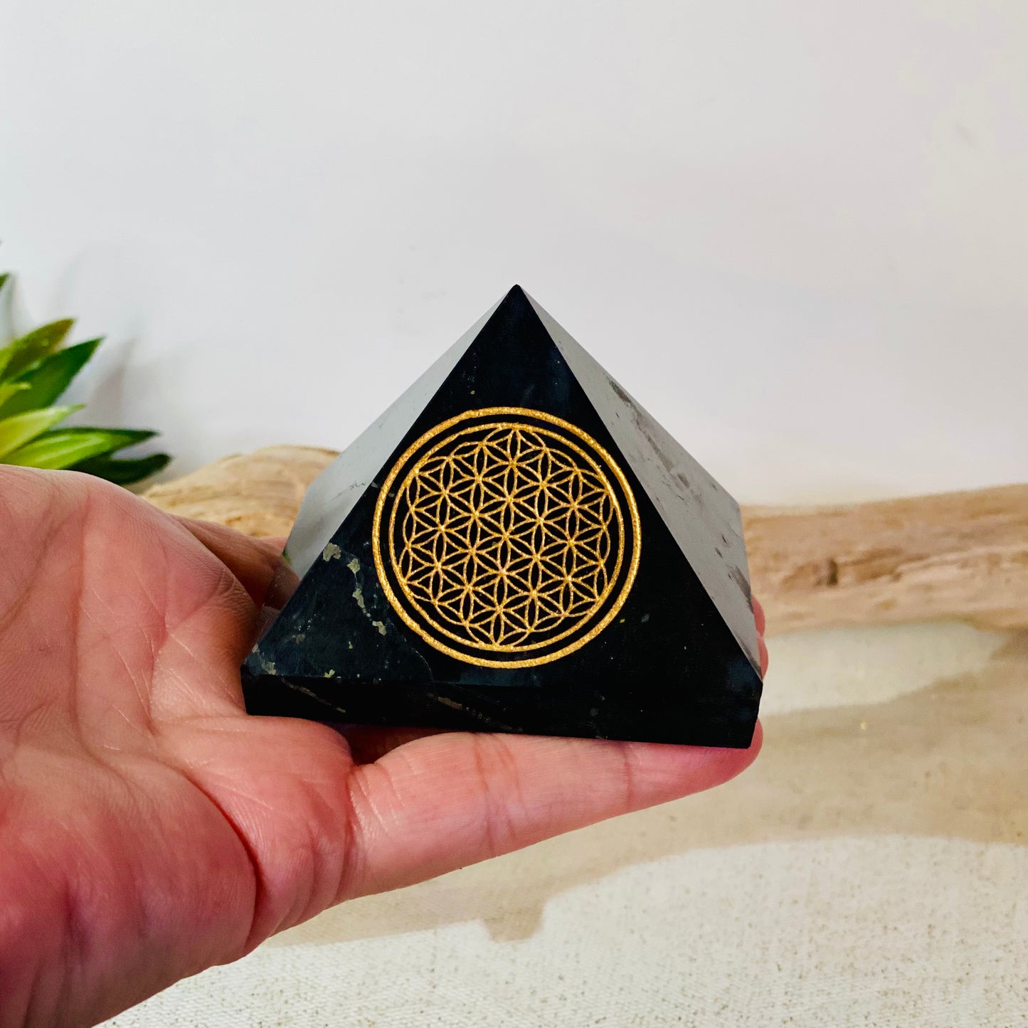Harmonizing Energies: Shungite Pyramid with Gold Flower of Life Engraving
